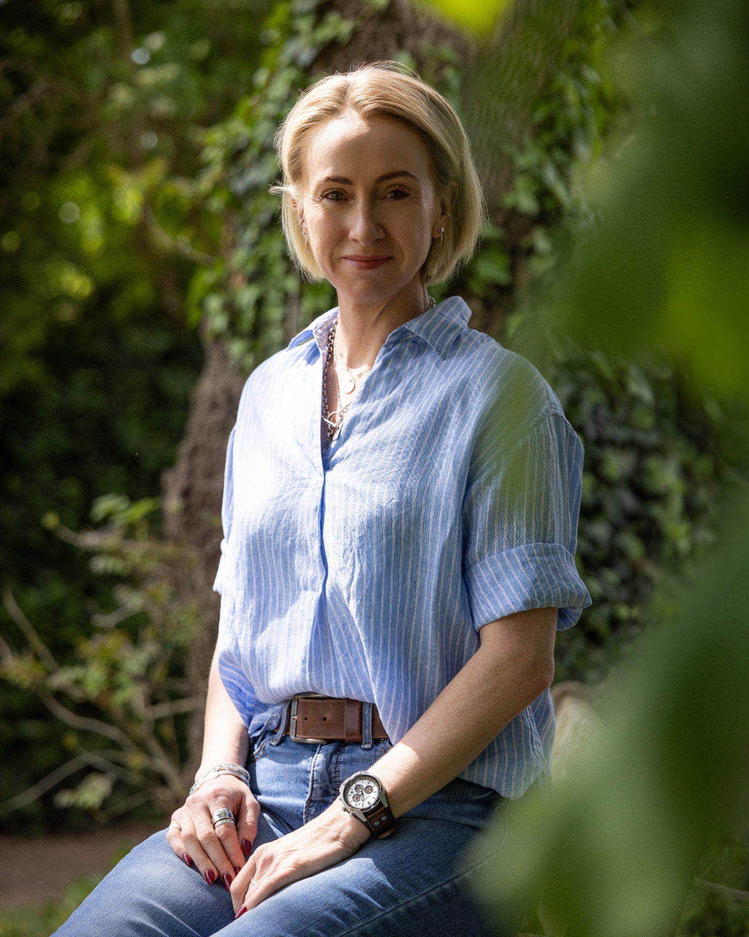 Kate Ramsay sitting outdoors among greenery