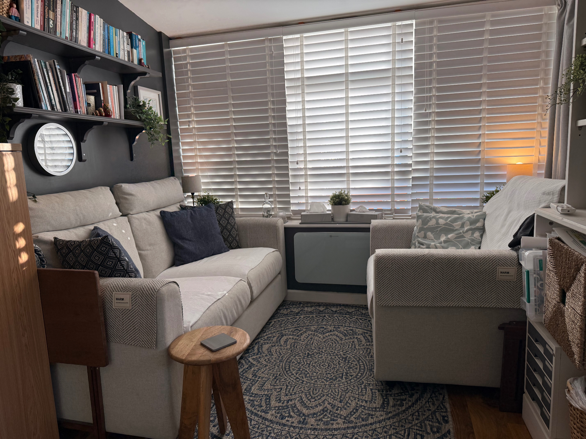 Kate Ramsay's therapy room - welcoming space with bookshelves and warm lighting