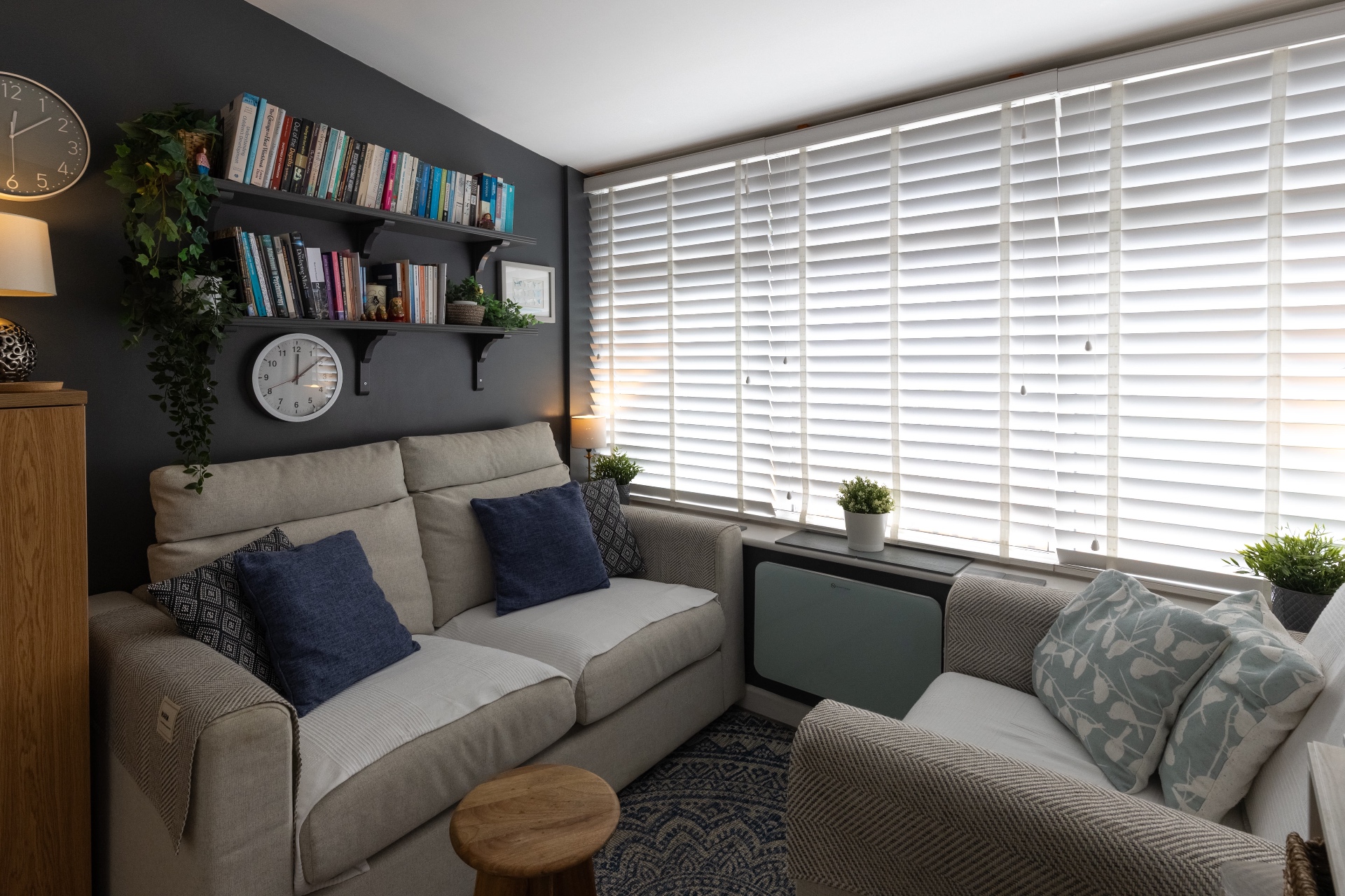 Kate Ramsay's therapy room - bright space with sofas, bookshelves and large window